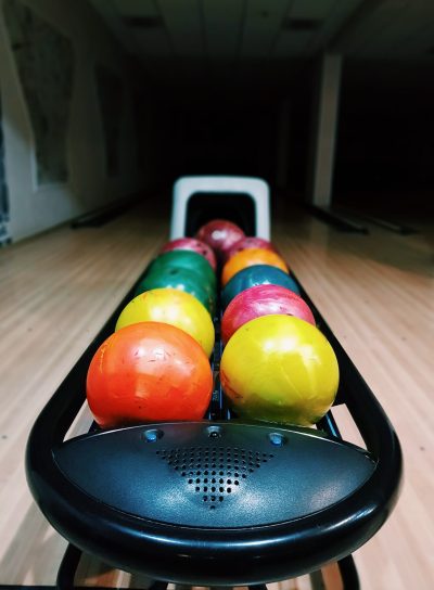 Close-up of colorful bowling bowls in bowling alley.